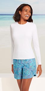 A woman in a crew neck long sleeve swim tee.